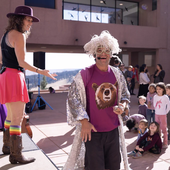 The Jeff and Paige band performing to a group of children outside.