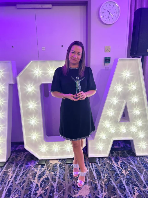Gemma Wardell stood smiling with her award.