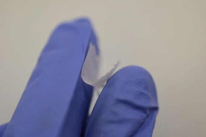 The nanofiber mat, about 2cm across, held between two fingers