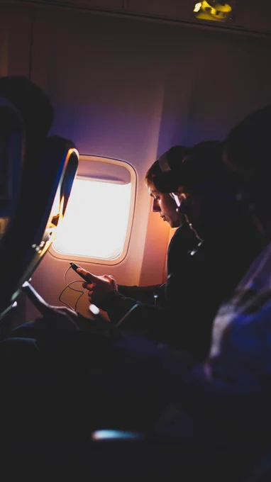 Man sitting in the window seat of an aeroplane