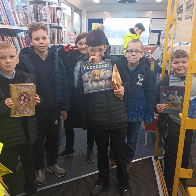 Children choosing books on the mobile library