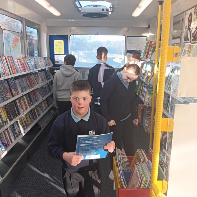 Children choosing books on the mobile library