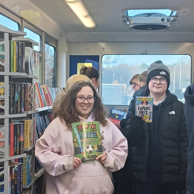 Children choosing books on the mobile library