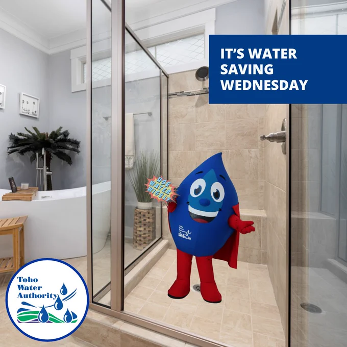 Shown is a shower with Toho's mascot Hydro. They are holding a sign that says "use water wisely". Text on the image reads "It's Water Saving Wednesday" with Toho logo in the bottom left corner. 