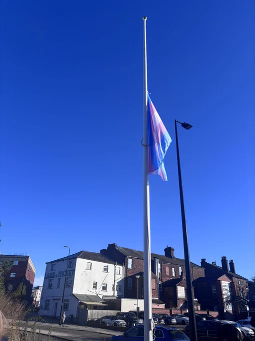 The transgender flag flying at half mast
