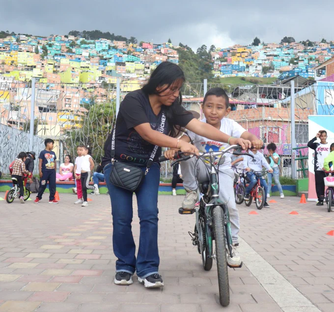 Woman teaching child how to cycle