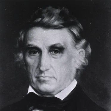 Black and white portrait image of William Beaumont, a man in a suit
