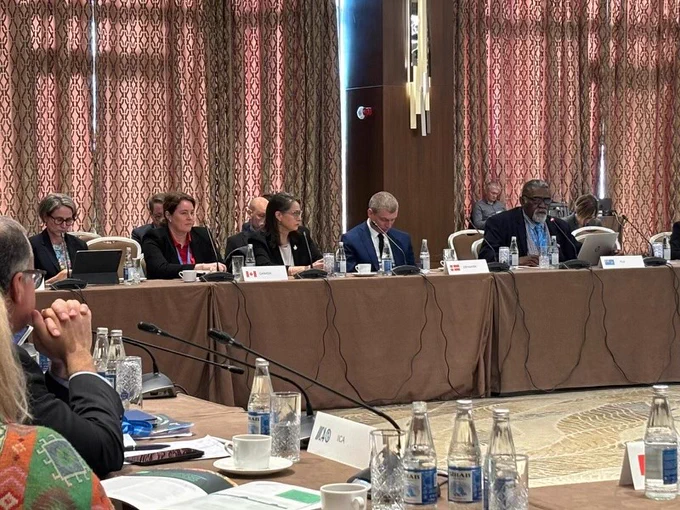 Canada’s Ambassador for Climate Change, Catherine Stewart sitting with international delegates for an agricultural negotiation. 