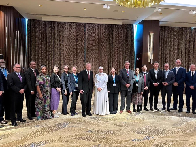 Canada’s Ambassador for Climate Change, Catherine Stewart standing with delegates for a group photo. 