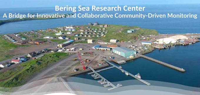An aerial view of St. Paul, with the text "Bering Sea Research Center, A bridge for innovative and collaborative community-driven monitoring."