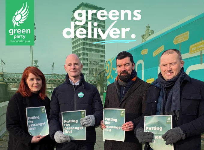 Nesa Hourigan, Ossian Smyth, Joe O'Brien and Ian Carey stand in front of Liberty Hall at Custom House Quay in Dublin, holding signs saying 'Putting the Passenger First'