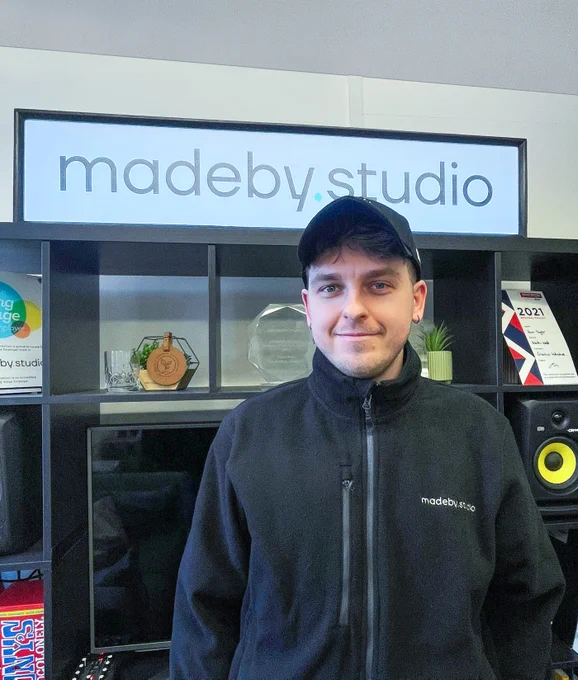 Liam in front of madeby.studio sign