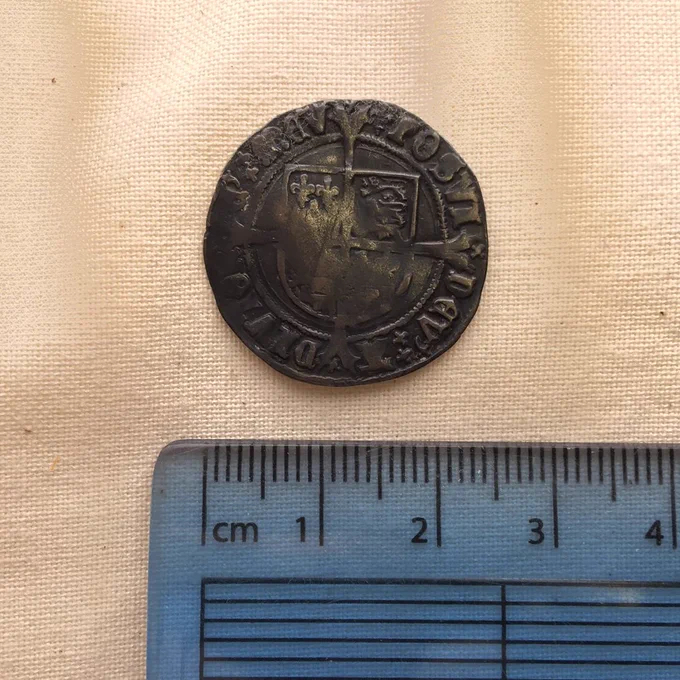 Reverse of a King Henry VIII groat with a ruler showing that it is approx. 23mm in diameter