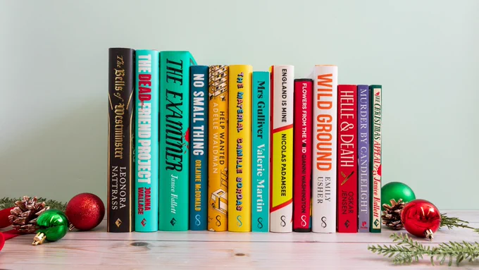 A selection of Serpent's Tail and Viper books arranged on a shelf, with Christmas decorations surrounding them.