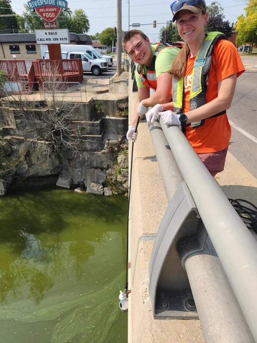 Carolyn Soderstrom and Ian Halteman collect a water sample from the Fox River at Ottawa, Illinois (credit: Carolyn Soderstrom).