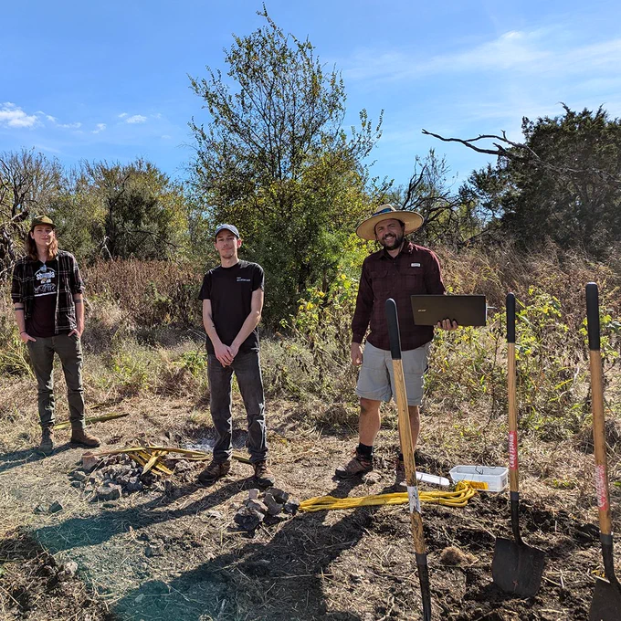 Some of the Archaeology Club members outside of the Archaeology lab demonstrating and learning creating and cooking in an earth oven.