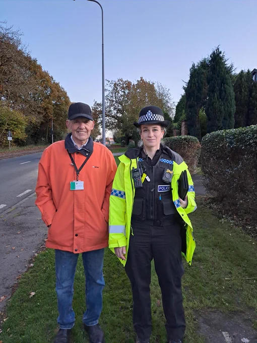 Police officer with councillor, speed checks. 