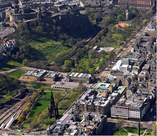A view from above of Princes Street, Waverley Station, the National Galleries and East and West Princes Street Gardens.