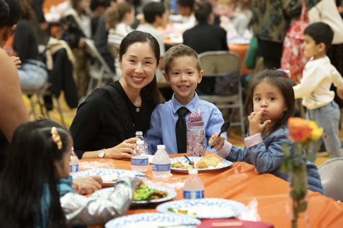Adult and child at Thanksgiving event. 