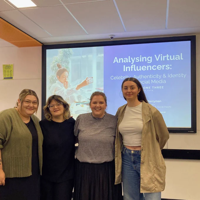 A group photo of all IERLab Research Students following Rachel Berryman's Milestone 3 presentation. L-R: Naomi Robinson, Janey Umback, Rachel Berryman, Faye Mercier.