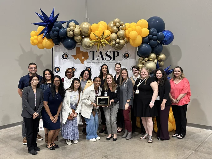 Group photo of team with award.