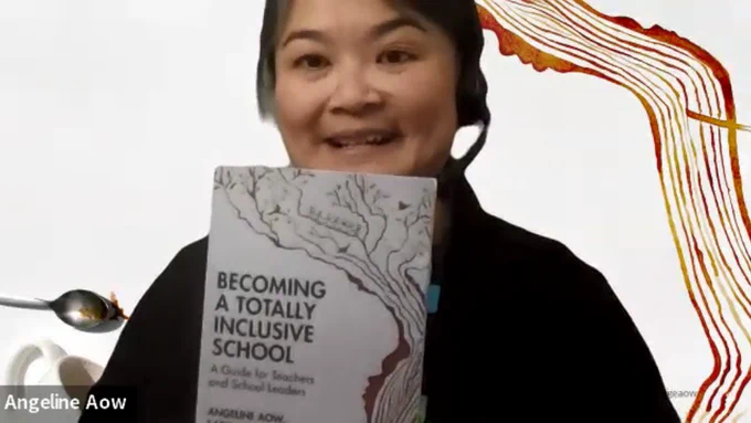 Angeline has her black hair tied back and is wearing a one-ear headset with a mic coming down one side of her face. She smiling and holding a copy of Becoming a Totally Inclusive School in front of her. She is wearing a black woollen sweater. The background image is the coffee spill artwork from Xoái David that is also the cover of the book.