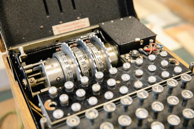 An old cryptography machine, with three dials and a number of keys.