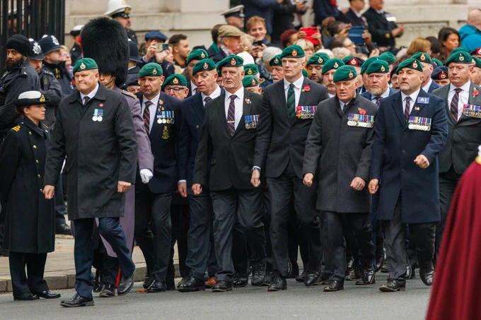 Defence Minister Al Carns, who served with the Marines, marches (centre).