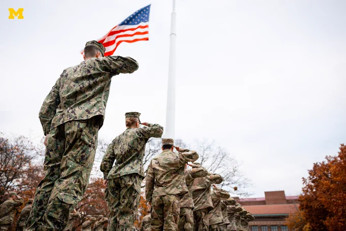 U-M ROTC members salute the flag on the Diag.