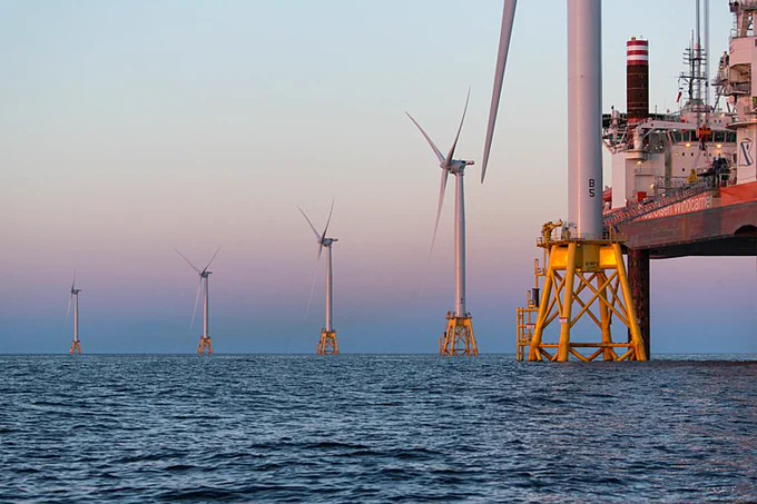 Photo: Dusk settles on the Block Island Wind Farm on the last day of construction. Credit: Joan Sullivan / Climate Visuals