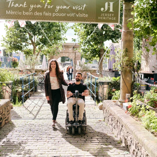 woman walking, man in motorised wheelchair
