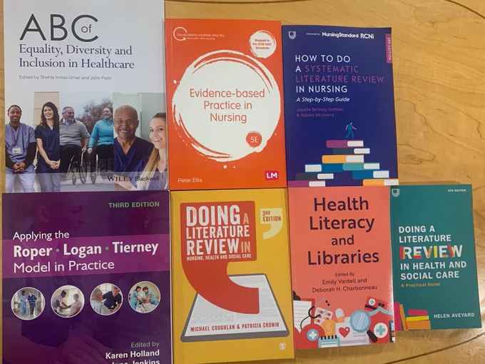 Books side by side on desk (titles; ABC of Equality, Diversity and Inclusion in Healthcare; Evidence-based Practice in Nursing; How to do a Systematic Review in Nursing; Applying the Roper Logan Tierney Model in Practice; Doing a Literature Review in Nursing, Health and Social Care; Health Literacy and Libraries; Doing a Literature Review in Health and Social Care)