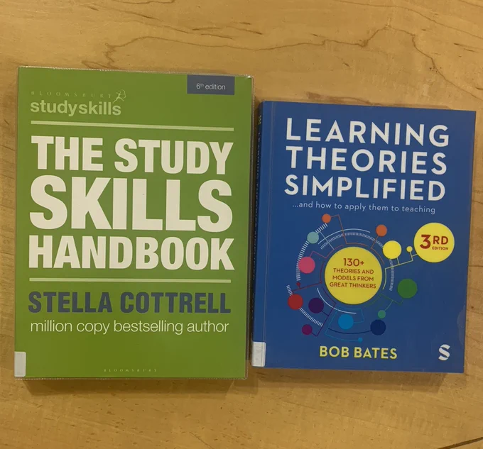 Two books on desk (titles; The Study Skills Handbook; Learning Theories Simplified)