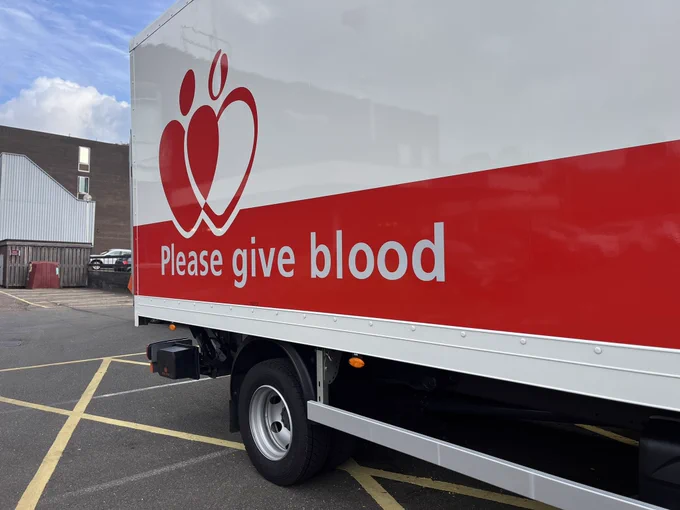 Blood van that says please give blood