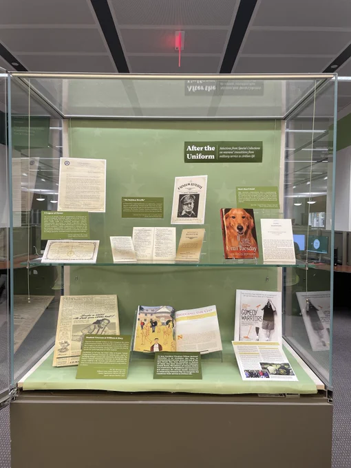 Veterans Day display in Swem lobby includes Special Collections items and books related to veterans military service and transitions back to civilian life. Themes include animal service in the military, William & Mary students who served, rosters and certificates of services, and more.