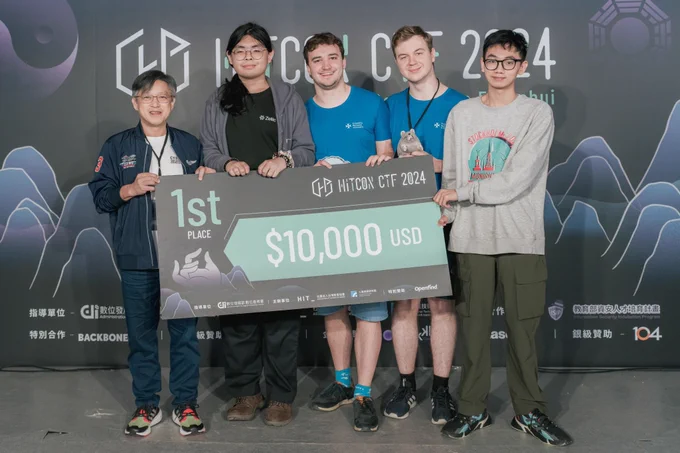 takarada, molenzwiebel, Trixter and piers posing with the $10k 1st place vanity cheque at the HITCON CTF 2024 Finals prize presentation ceremony