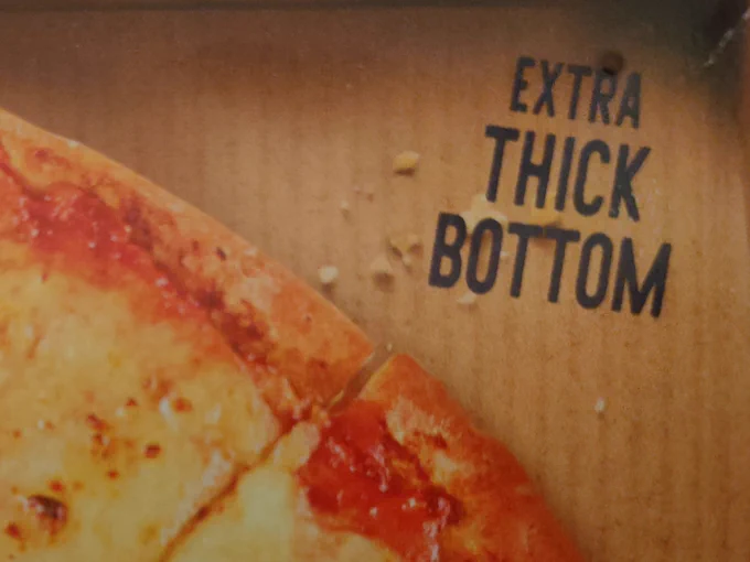 Frozen pizza box with "extra thick bottom" written in the top right corner