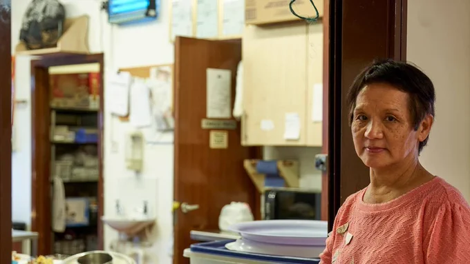 Older woman working in cafe