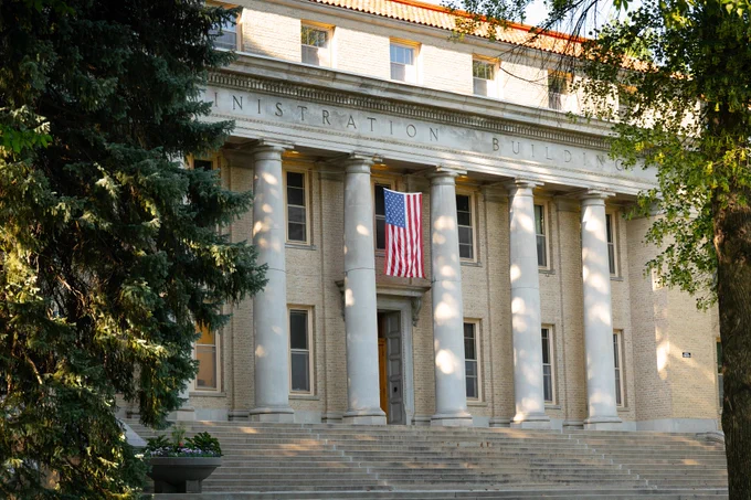 Photo of a flag hanging from the Admin building at the CSU campus