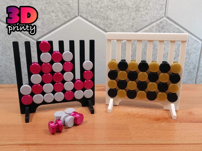 Photo of two 3D printed "Four-in-a-Row" game boards. The board on the left is loaded with pink and white game tokens. The board on the right is loaded with black and gold tokens in a checkerboard pattern.