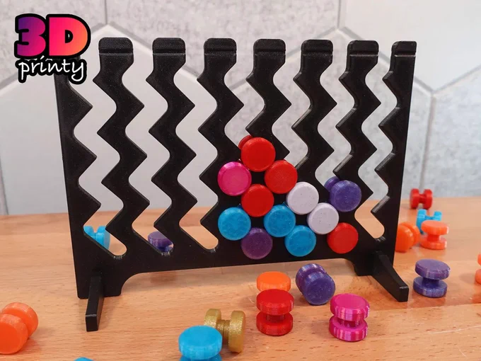Photo of a Zaggrivation board loaded with red, white, purple, and blue tokens.