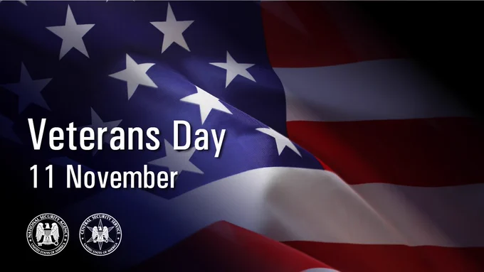 Image of an American flag, with the phrase "Veterans Day 11 November" on the left hand side above the NSA and CSS seals.