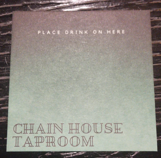 Chain house tap room beer mat with "place drink on here" printed on it.