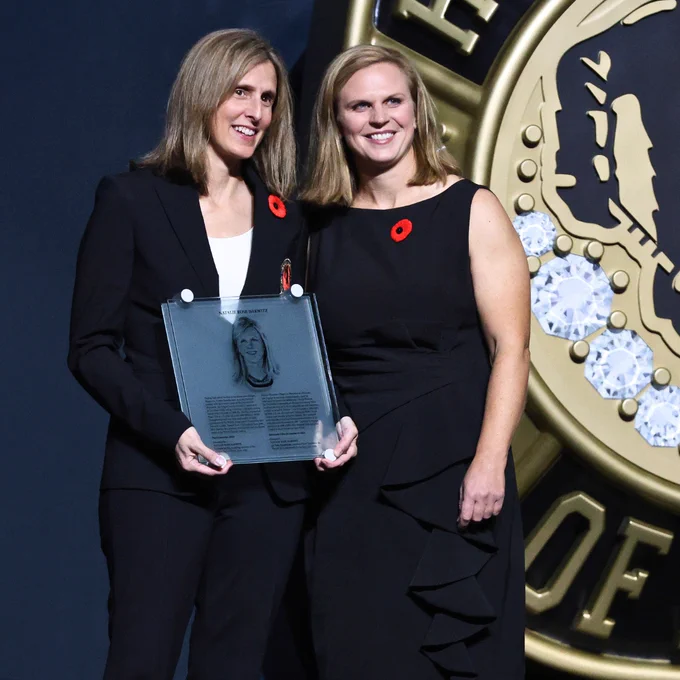 Natalie Darwitz (right) receives her Honoured Member plaque from Cammi Granato (left).