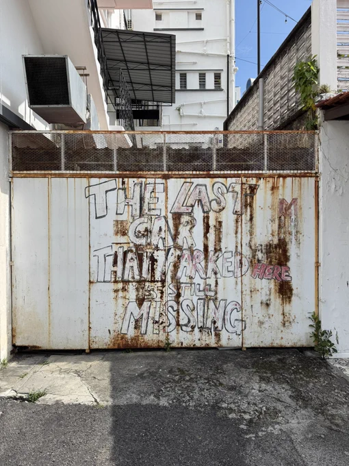 Graffiti on a driveway entrance door: “The last car that parked here is still missing”