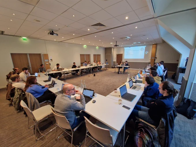 Photography of a meeting room with the Pangeo European developers in Paris. Tina Odaka and Anne Fouilloux (from left to right) in the central table.