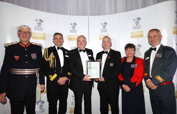 Vice-Chancellor Professor Mark Power and Dr Gus Ryrie both holding a certificate with two people stood either side of them dressed in military uniform
