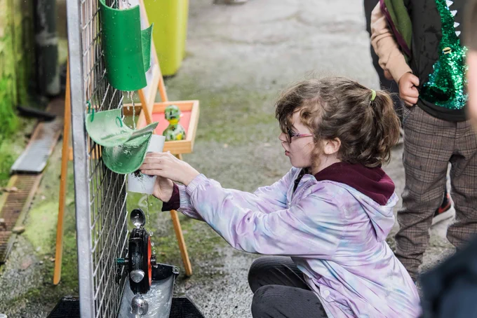Child pouring water into cup