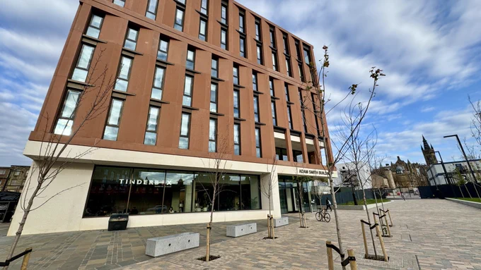 The Adam Smith Building from Dumbarton Road. Tinderbox in white letters in the window to the left and the University Tower to the right in the background. 