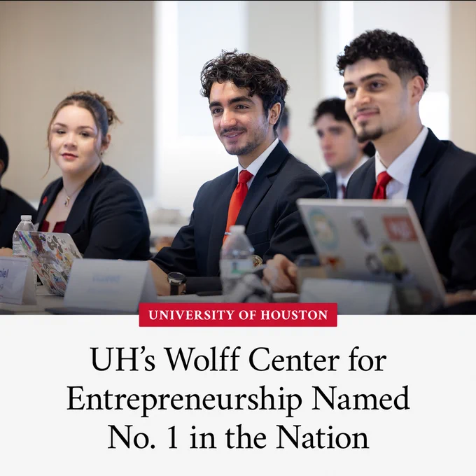 Group of University of Houston students in business attire sitting at a table, appearing engaged and attentive, with laptops open in front of them. The image highlights the University of Houston’s Wolff Center for Entrepreneurship being ranked No. 1 in the nation.